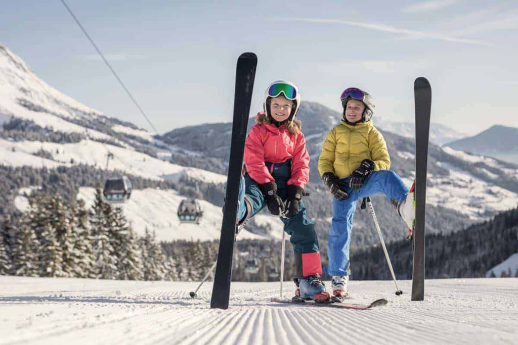 Kinder genießen den Skiurlaub in Mühlbach am Hochkönig bei strahlendem Wetter.