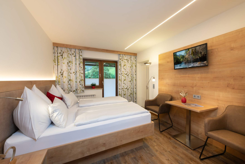 Gemütliches Schlafzimmer im Apartmenthaus Rainer mit Aussicht auf die Salzburger Berge.